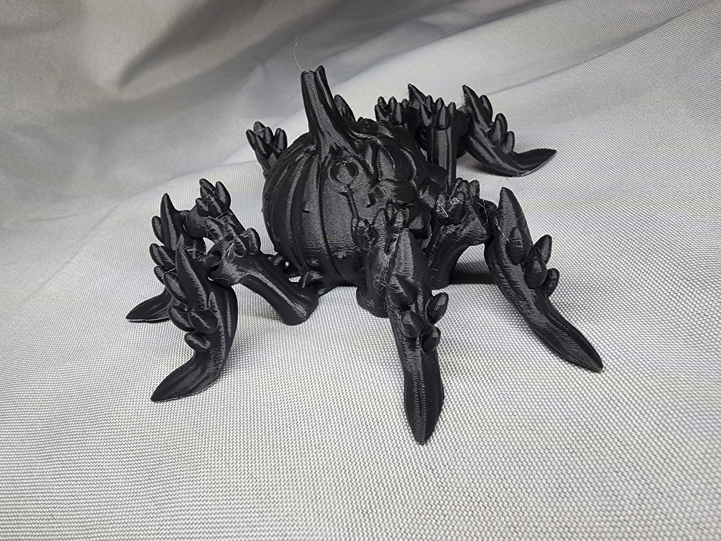Pumpkin Spider articulating figurine is a great addition to your creepy Halloween decor and fun to play with
