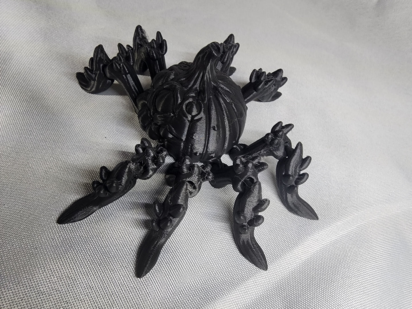 Pumpkin Spider articulating figurine is a great addition to your creepy Halloween decor and fun to play with