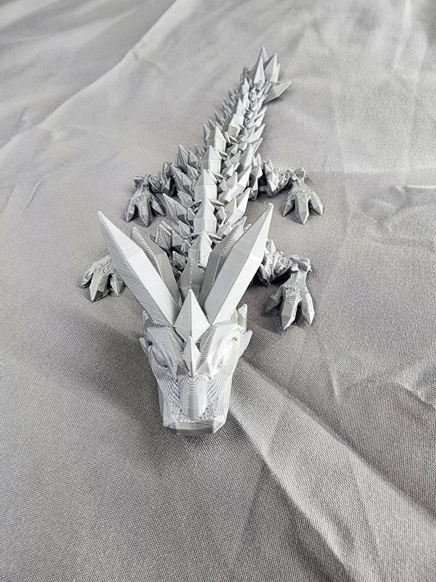 Crystal Baby Dragon articulating figurine with crystalline horns and a spiked crystal ball on their tail, these dragons are pint-sized and come in a rainbow of colors.