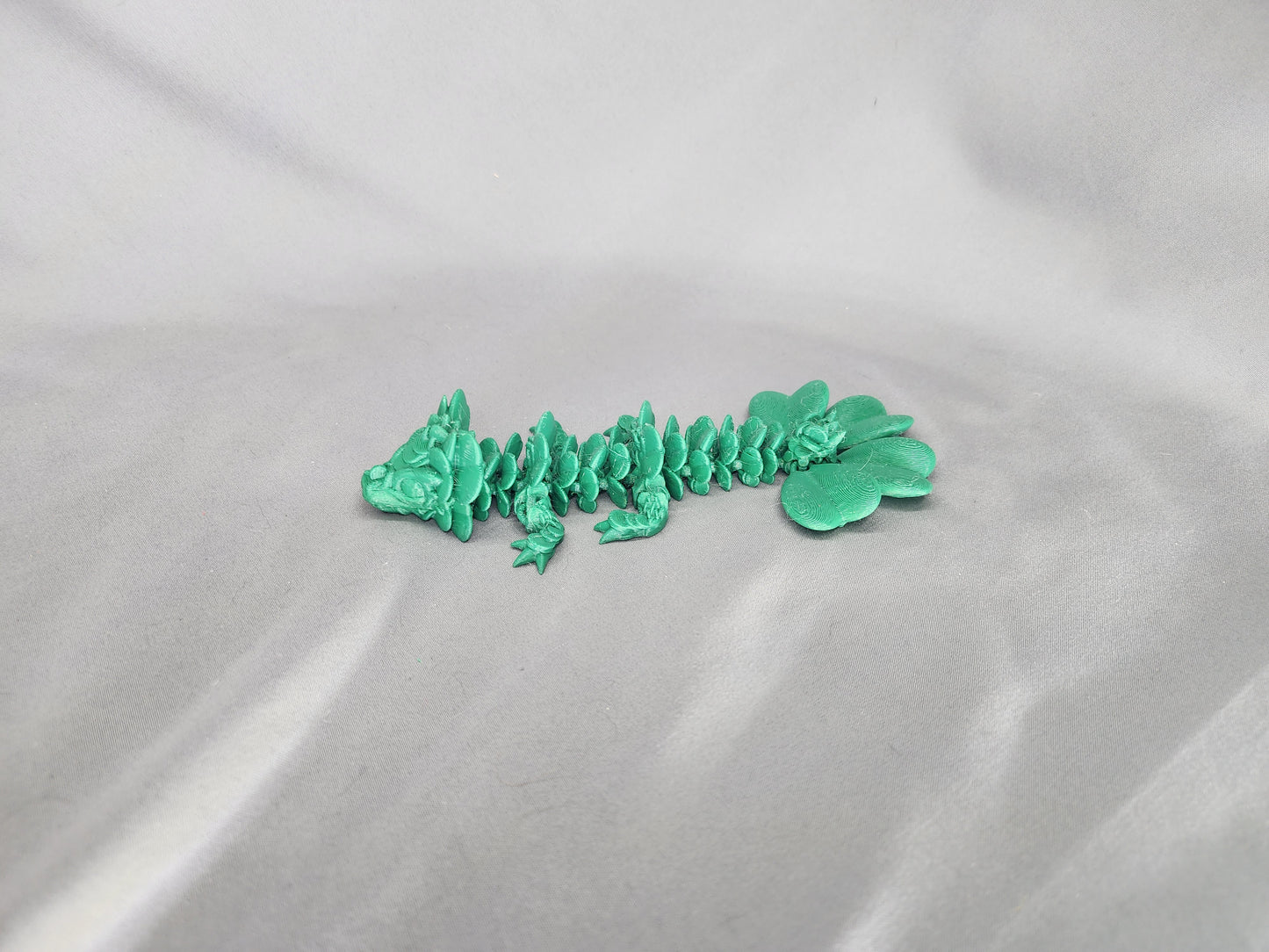 4 Leaf Clover Dragon Baby articulating figurine will surely bring some luck to your decor