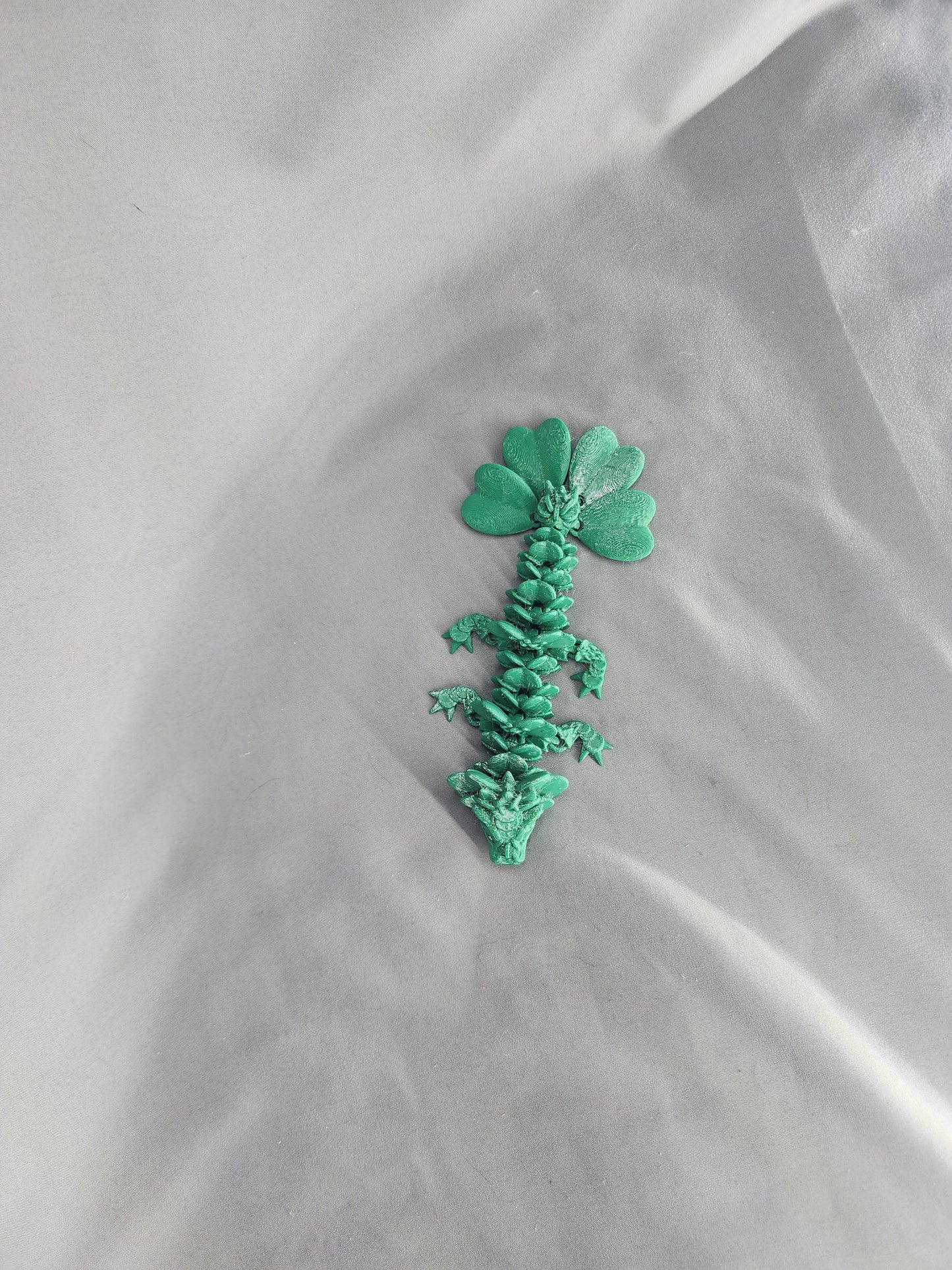 4 Leaf Clover Dragon Baby articulating figurine will surely bring some luck to your decor
