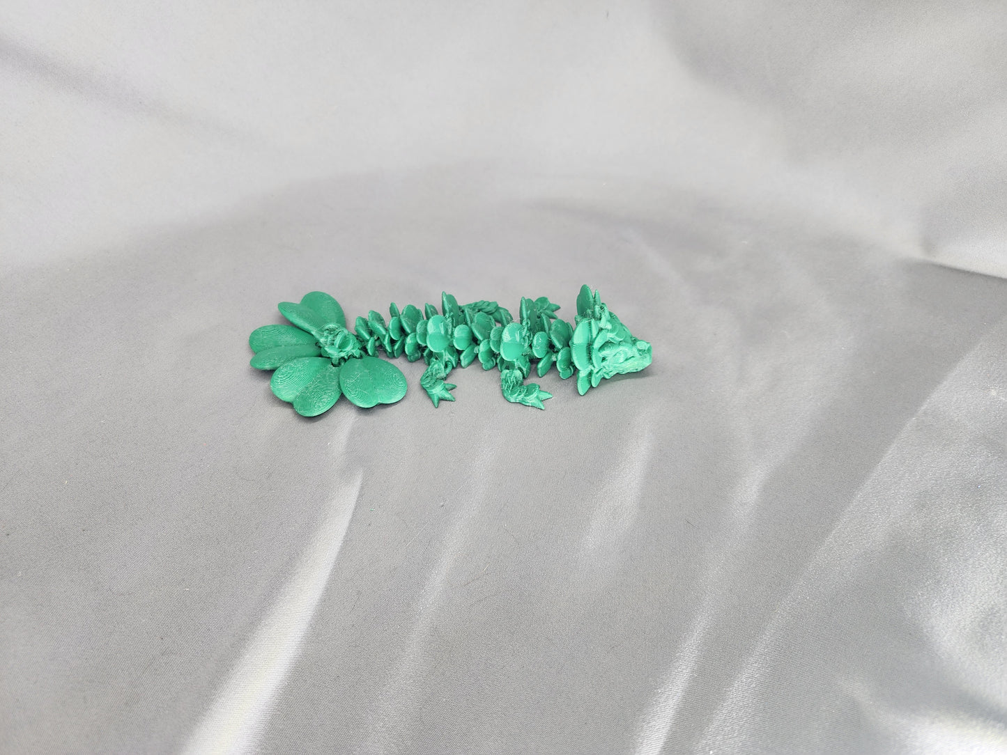 4 Leaf Clover Dragon Baby articulating figurine will surely bring some luck to your decor