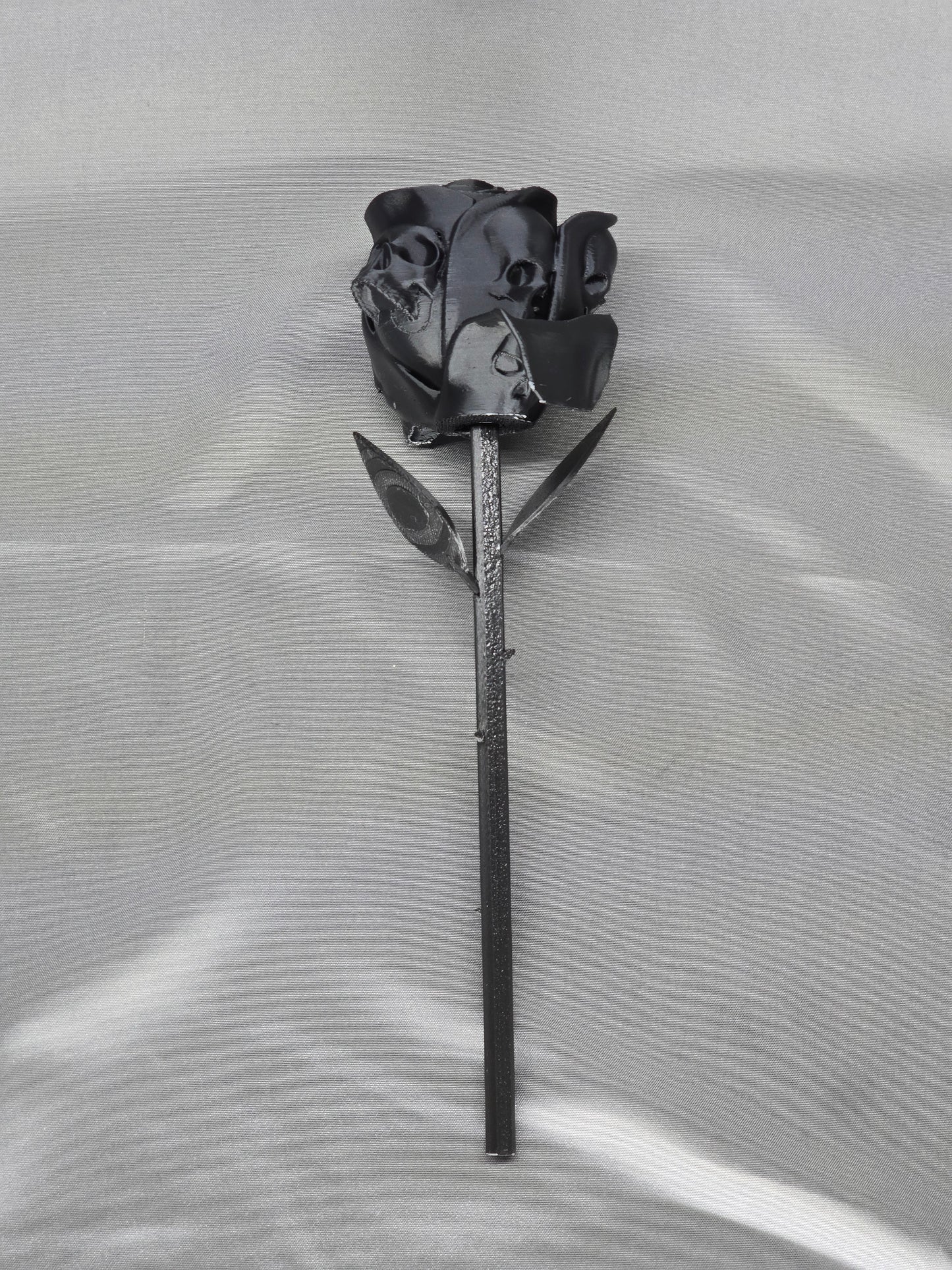 The Forbidden Rose decoration featuring a rose with thorns, 2 leafs and petals with skulls