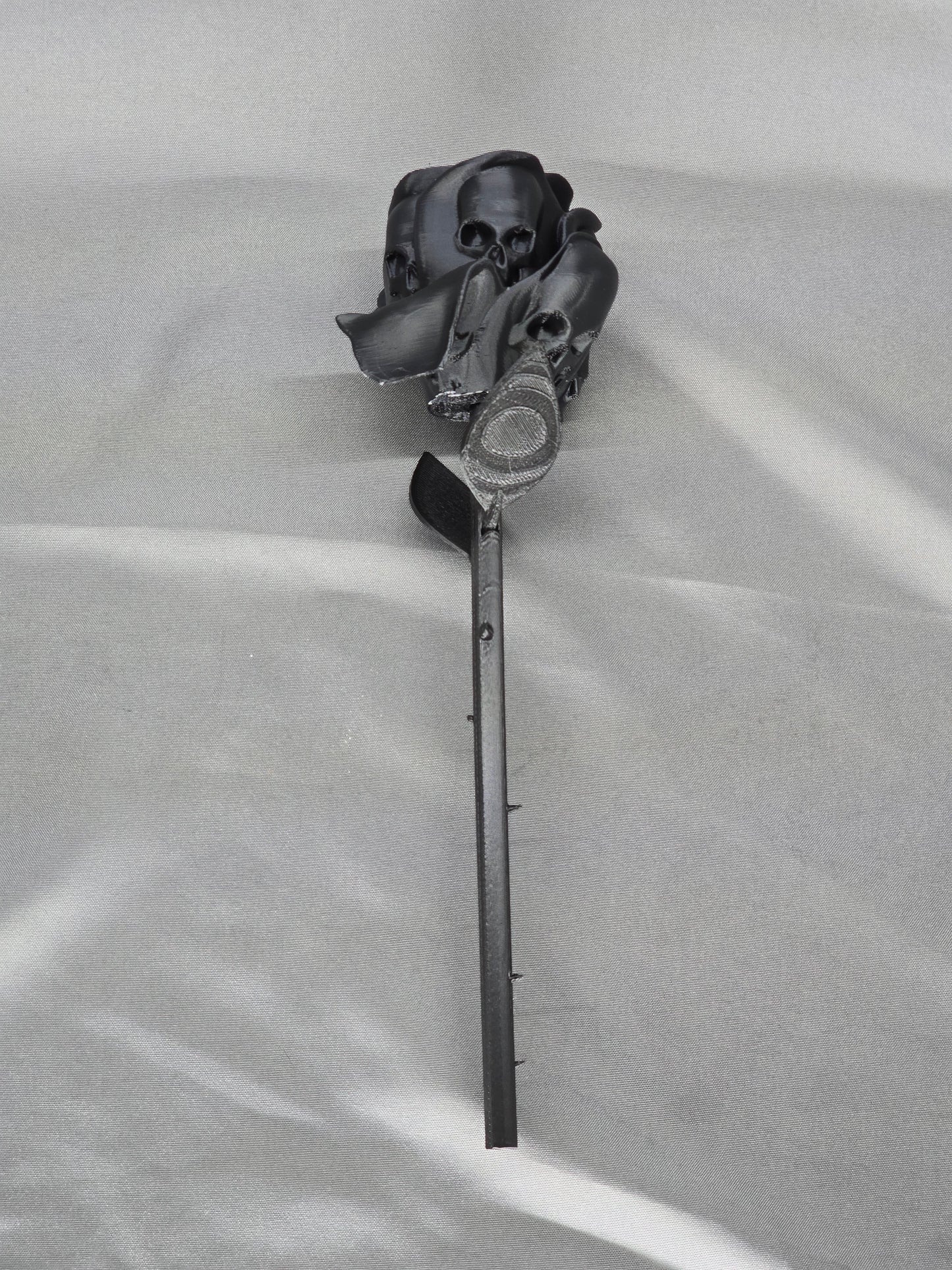 The Forbidden Rose decoration featuring a rose with thorns, 2 leafs and petals with skulls