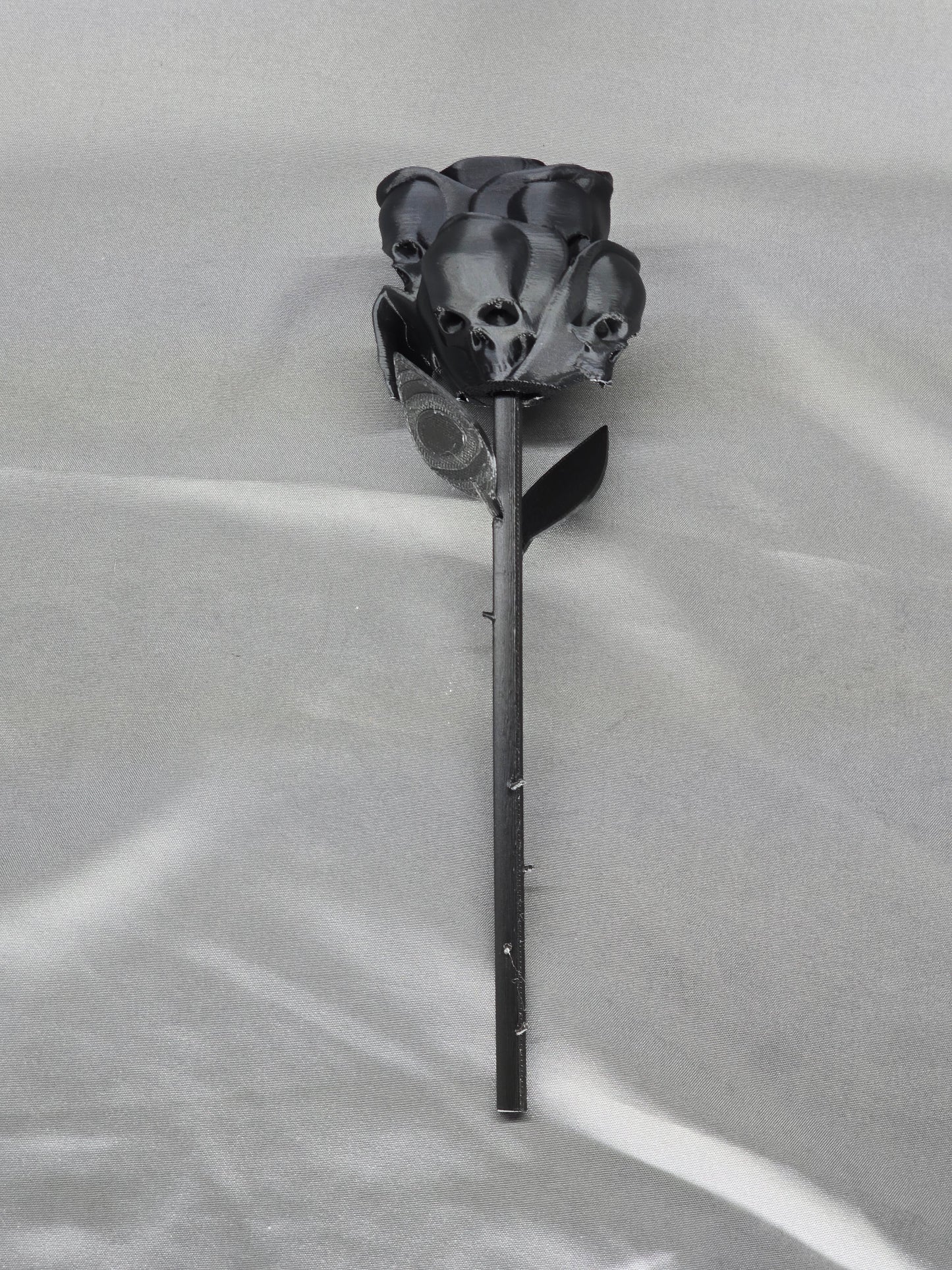 The Forbidden Rose decoration featuring a rose with thorns, 2 leafs and petals with skulls