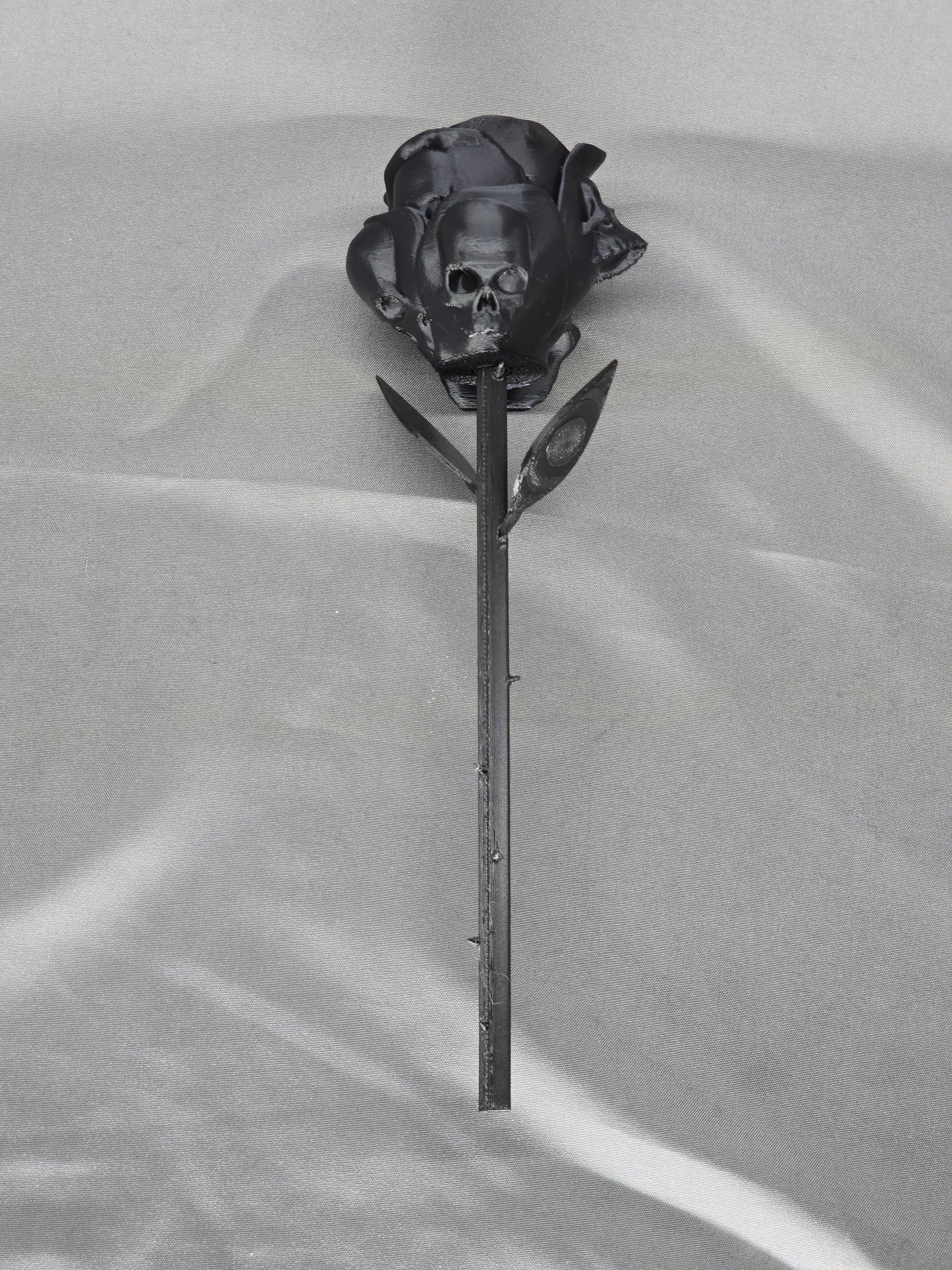 The Forbidden Rose decoration featuring a rose with thorns, 2 leafs and petals with skulls