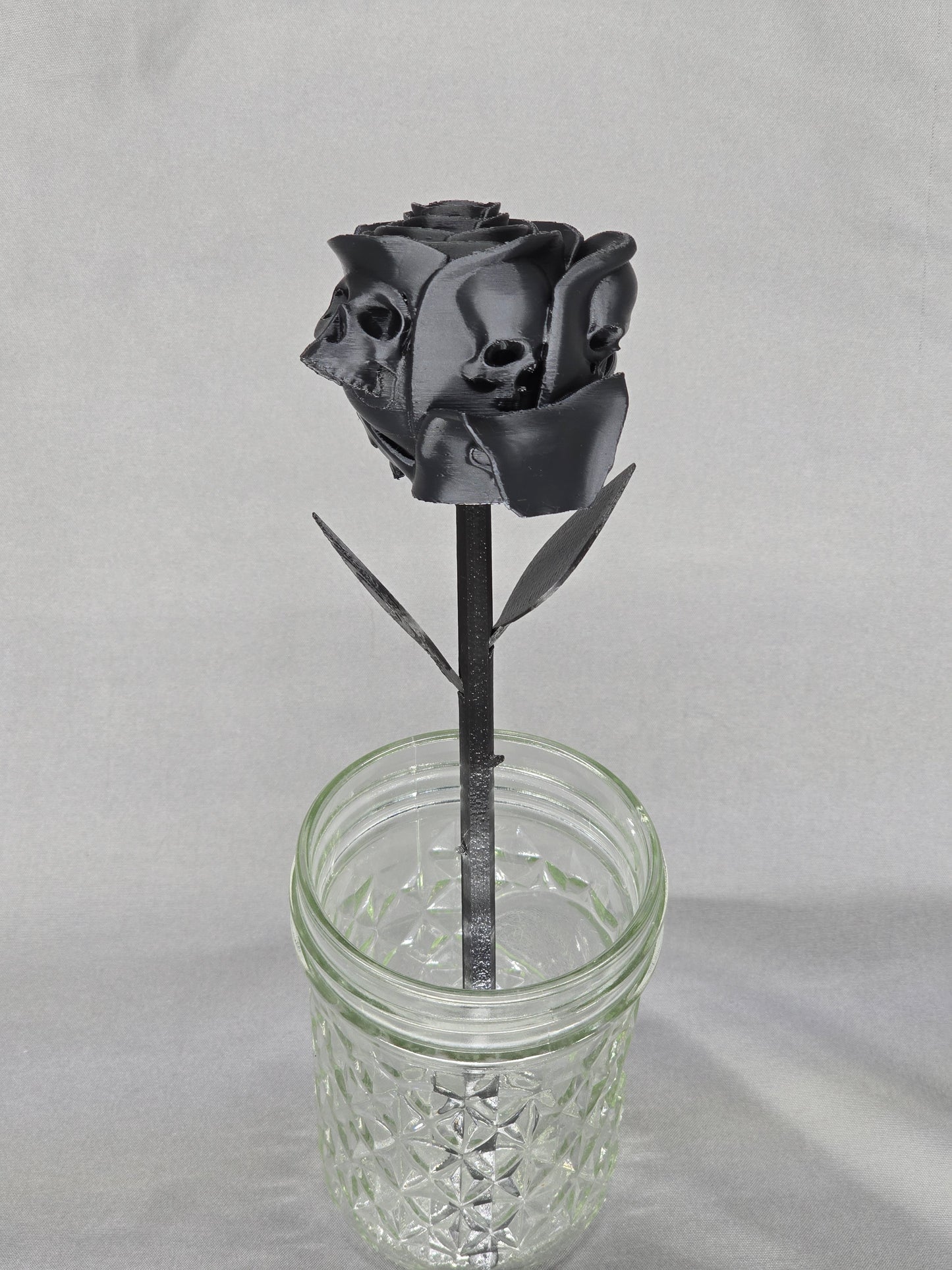 The Forbidden Rose decoration featuring a rose with thorns, 2 leafs and petals with skulls