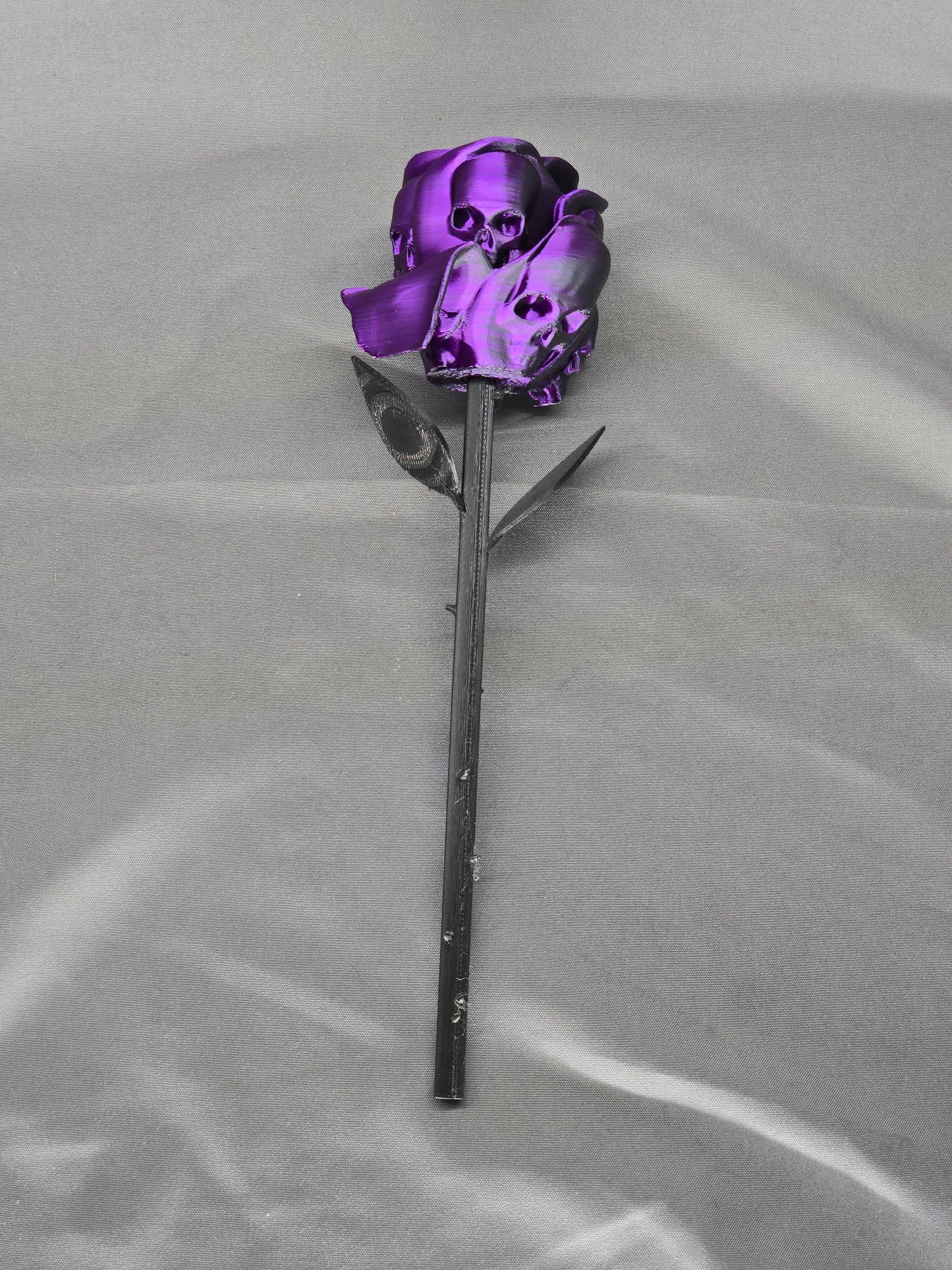 The Forbidden Rose decoration featuring a rose with thorns, 2 leafs and petals with skulls