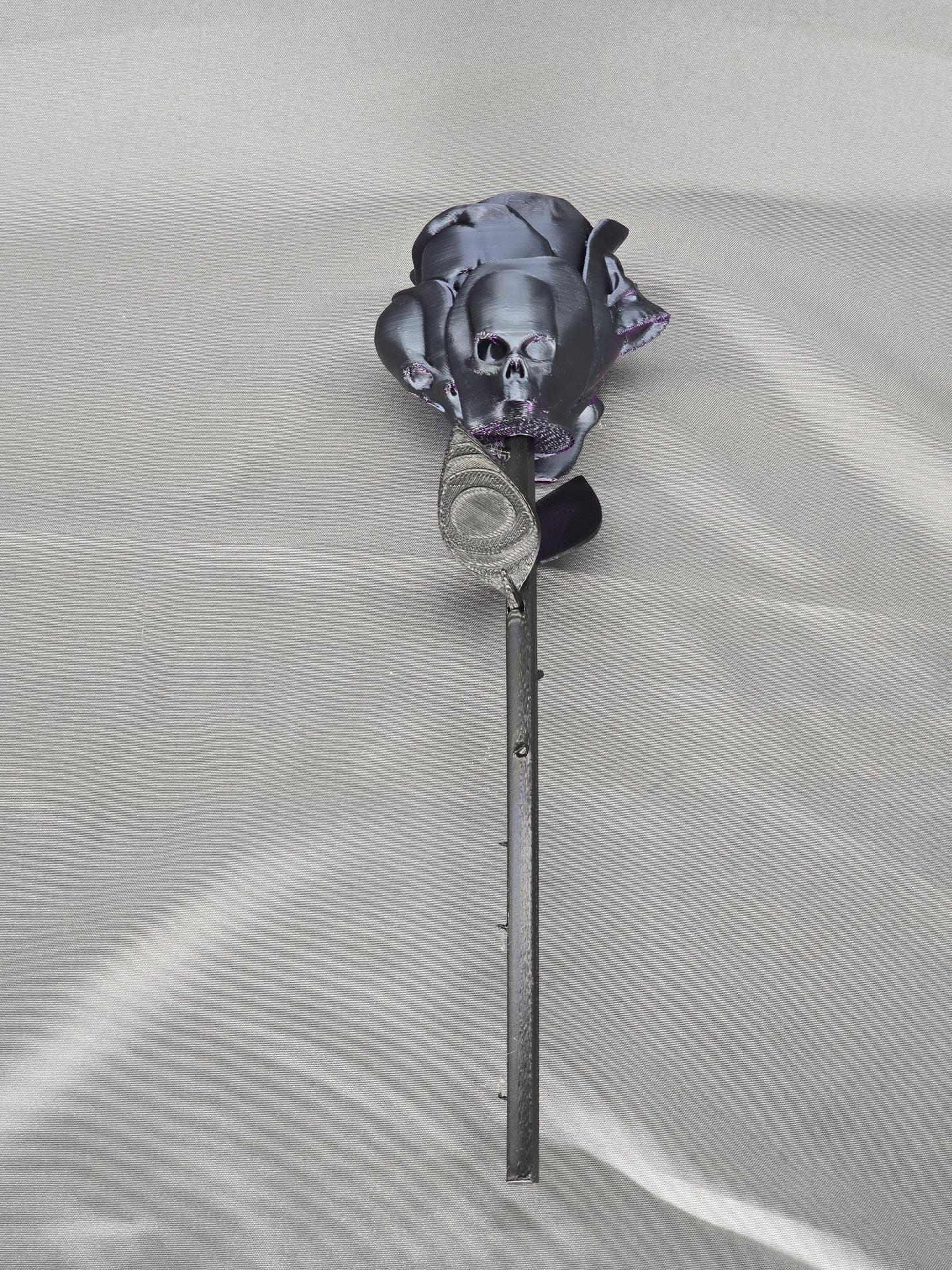 The Forbidden Rose decoration featuring a rose with thorns, 2 leafs and petals with skulls
