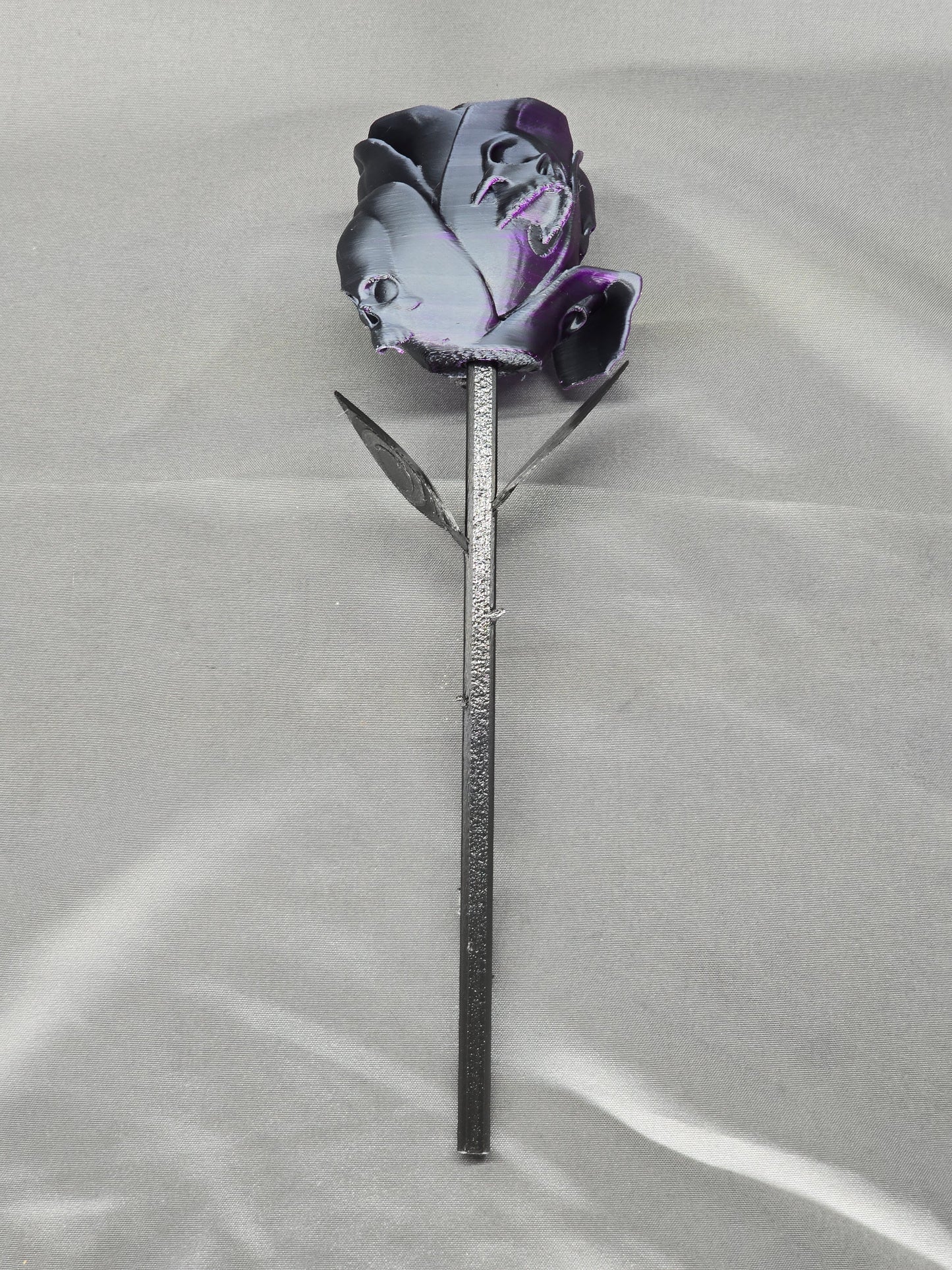 The Forbidden Rose decoration featuring a rose with thorns, 2 leafs and petals with skulls