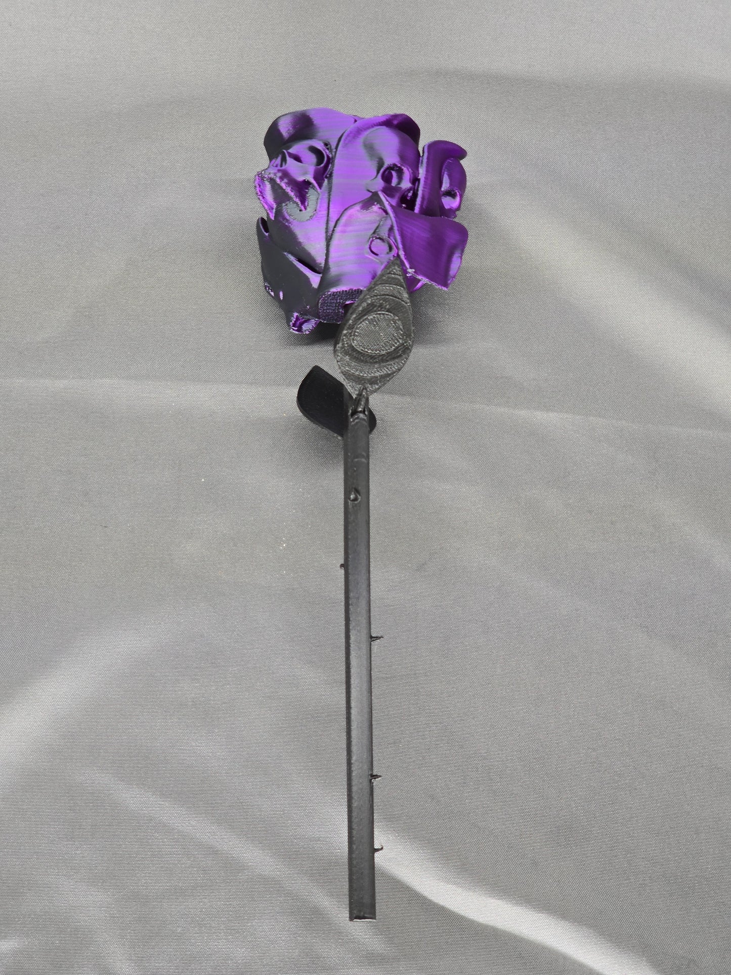 The Forbidden Rose decoration featuring a rose with thorns, 2 leafs and petals with skulls