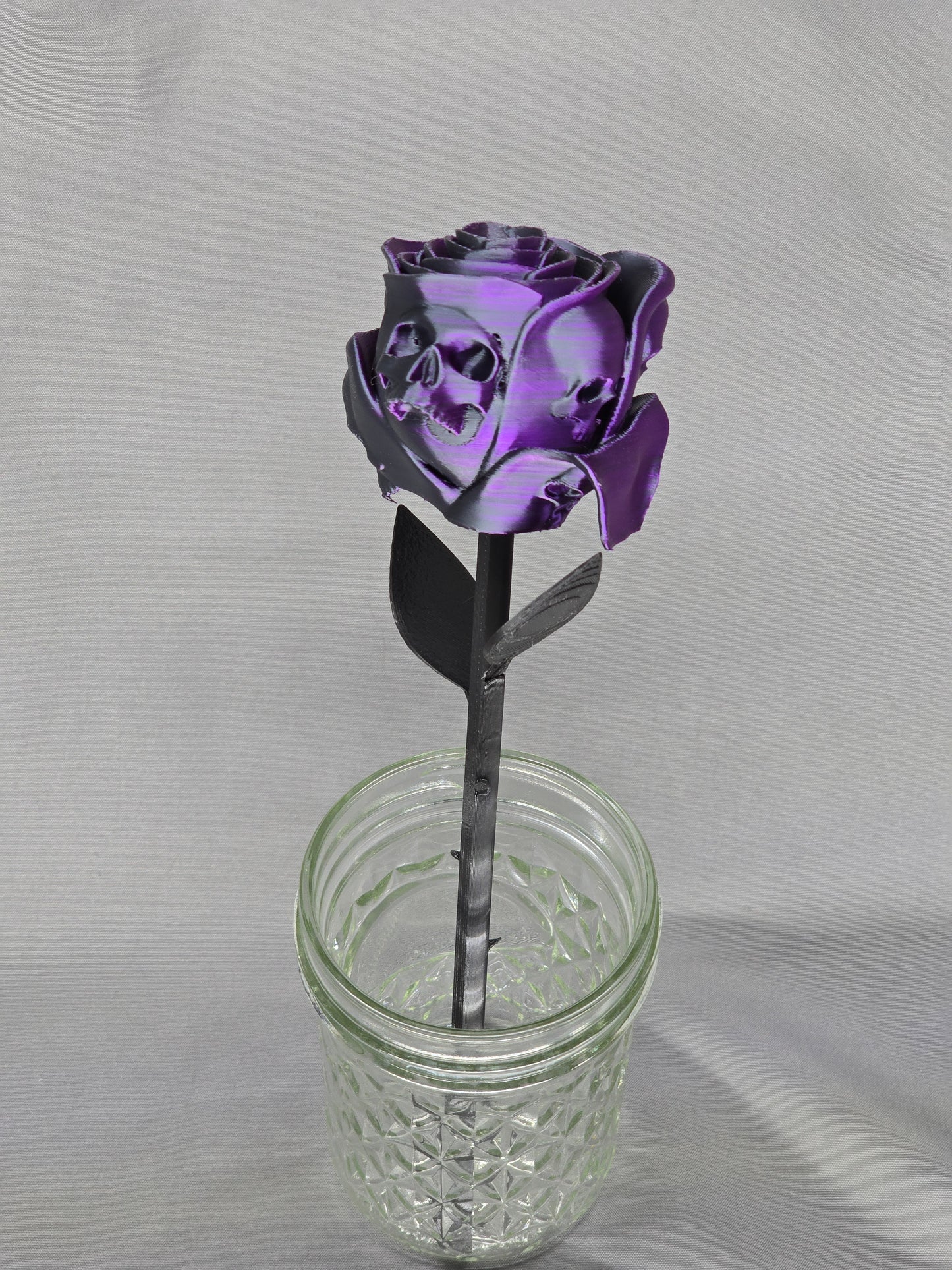 The Forbidden Rose decoration featuring a rose with thorns, 2 leafs and petals with skulls