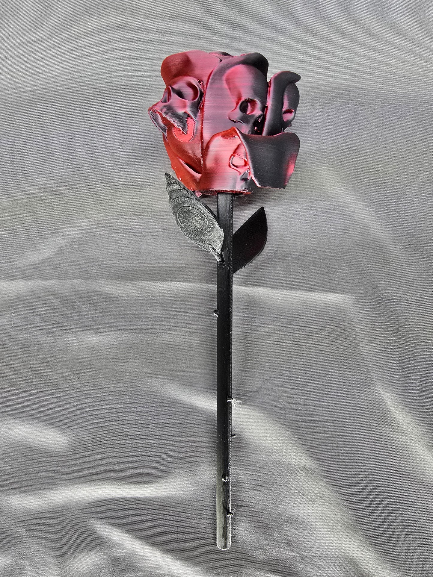The Forbidden Rose decoration featuring a rose with thorns, 2 leafs and petals with skulls