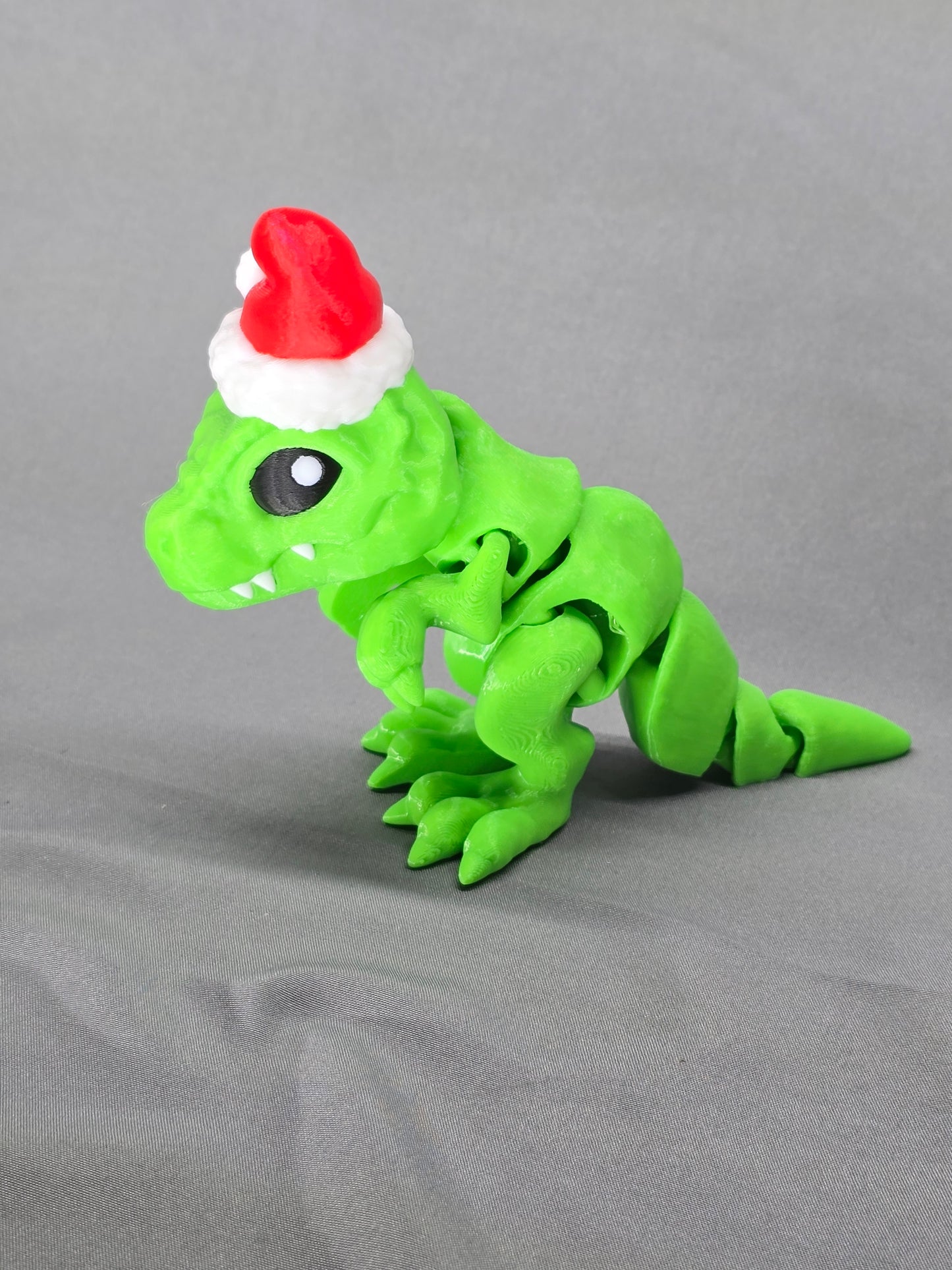 Tiny T-Rex Santa articulating figurine decoration will bring a lot of joy with a lot of teeth!
