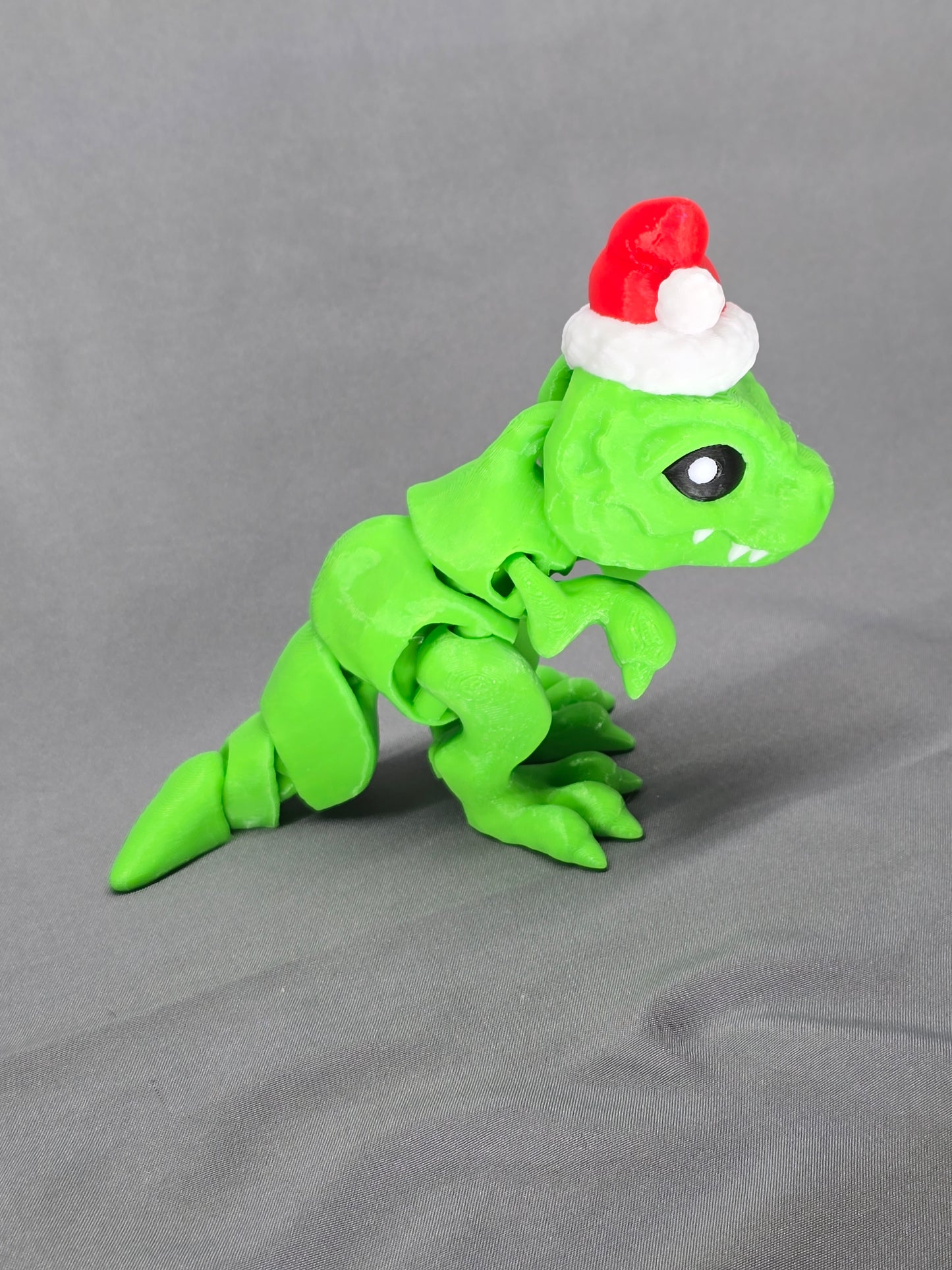Tiny T-Rex Santa articulating figurine decoration will bring a lot of joy with a lot of teeth!