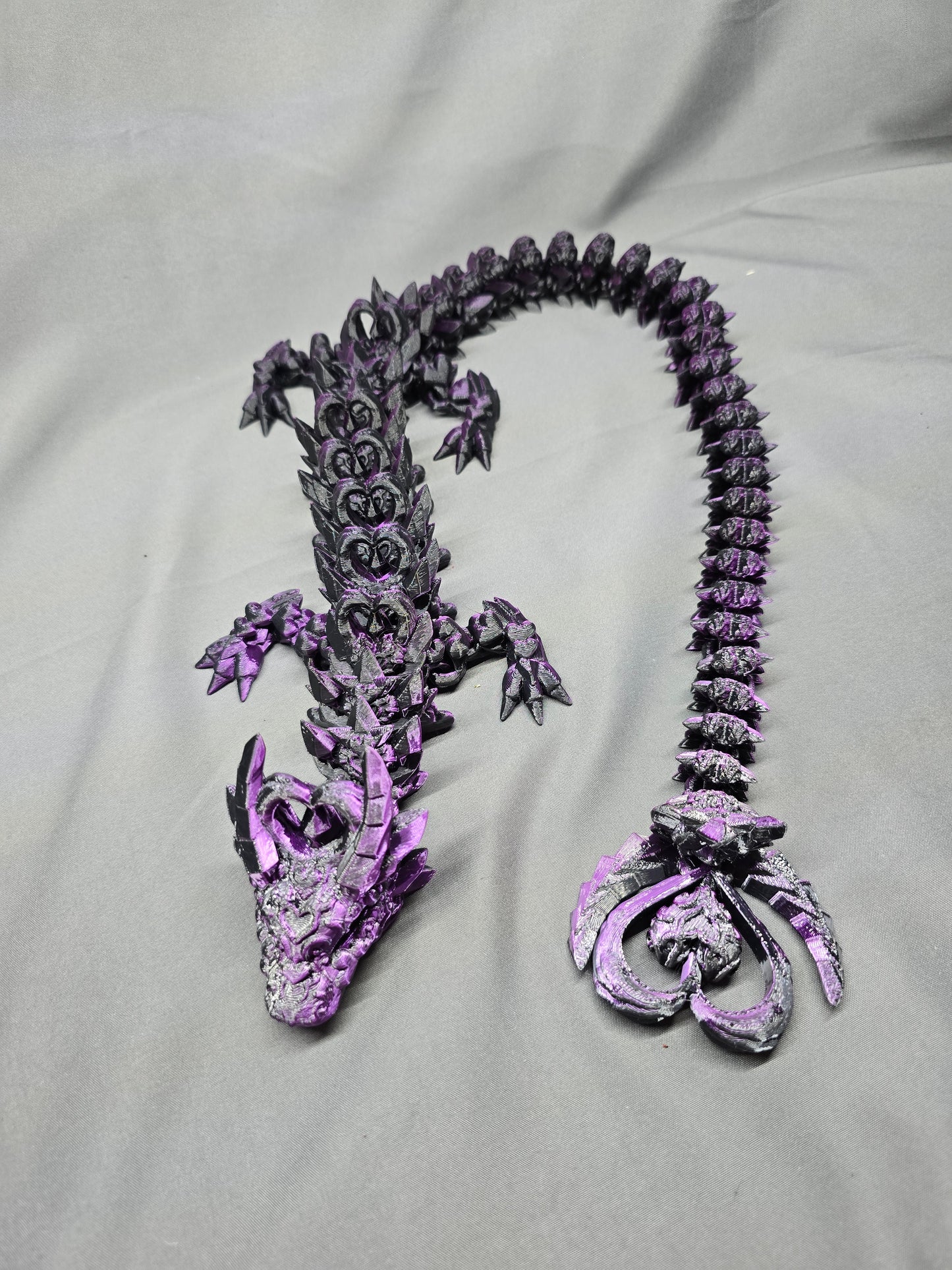 Dark Heart Dragon articulating figurine with a spinning heart tail