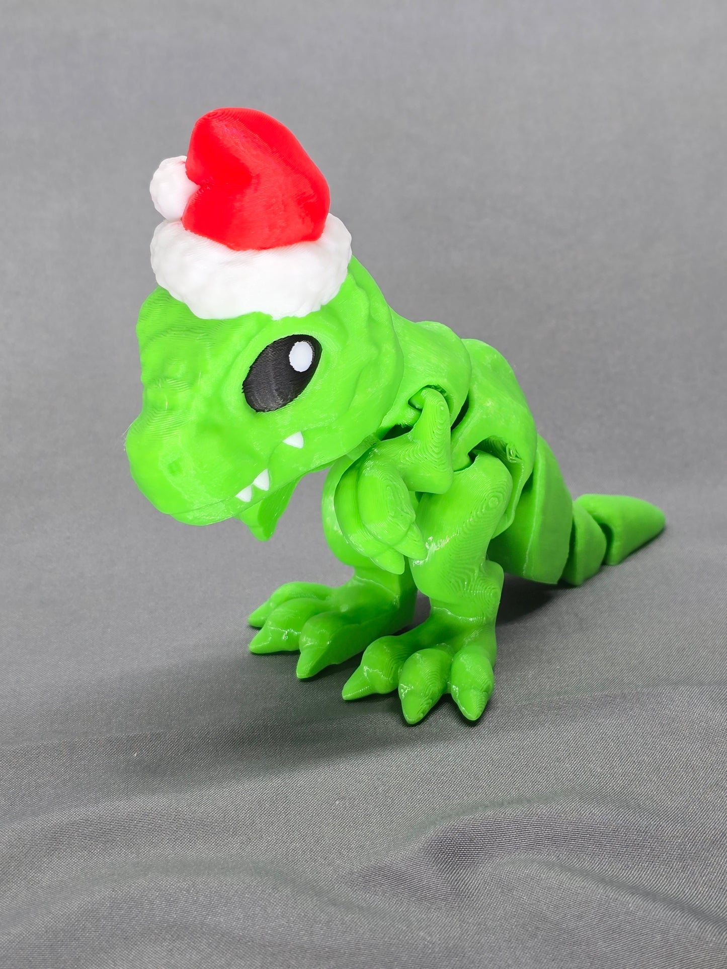 Tiny T-Rex Santa articulating figurine decoration will bring a lot of joy with a lot of teeth!