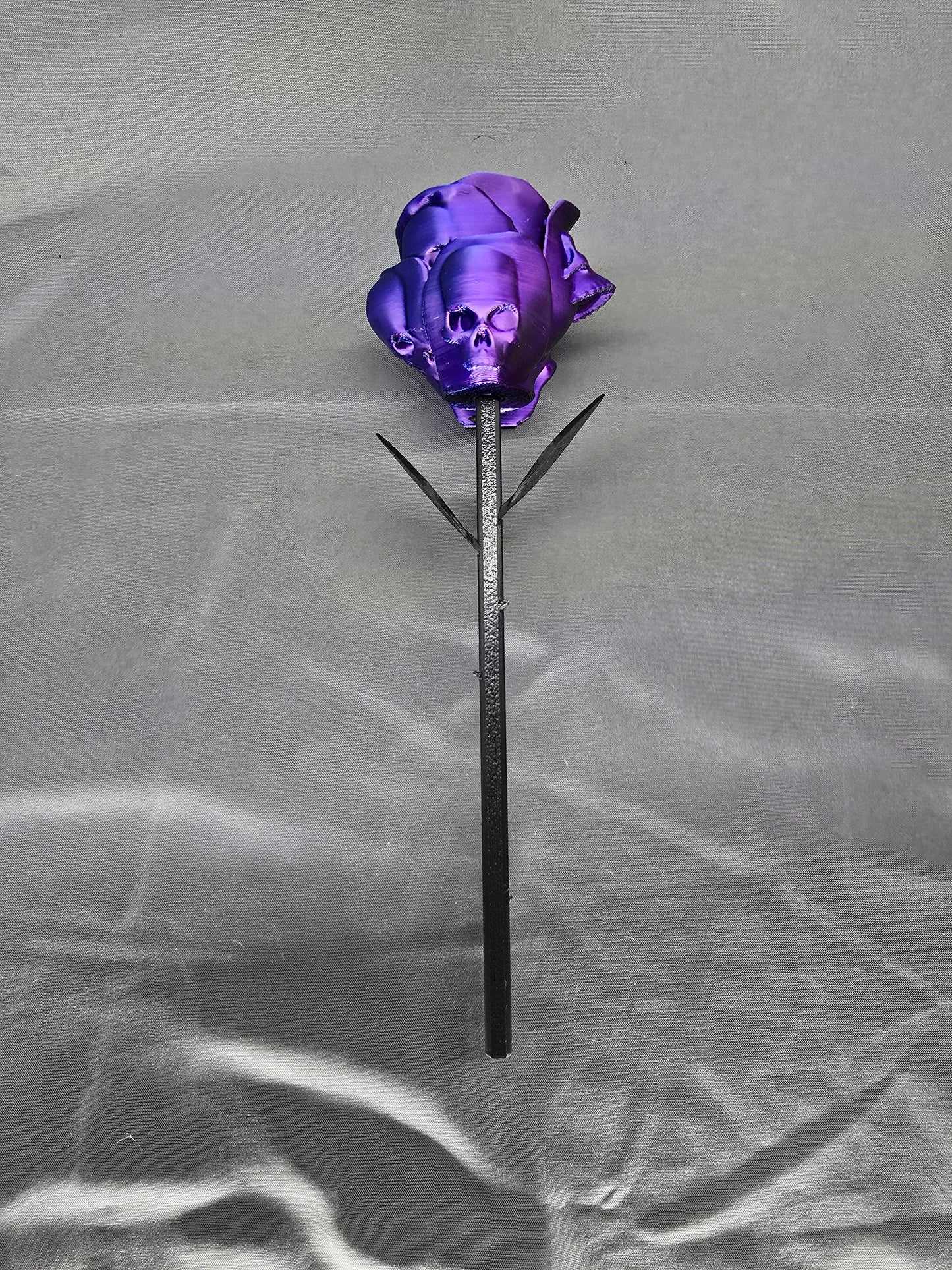 The Forbidden Rose decoration featuring a rose with thorns, 2 leafs and petals with skulls