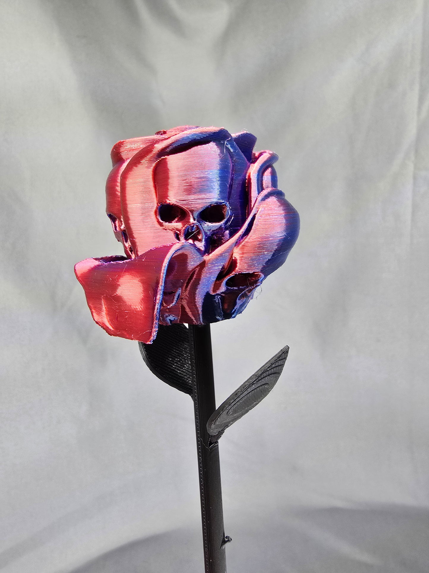 The Forbidden Rose decoration featuring a rose with thorns, 2 leafs and petals with skulls