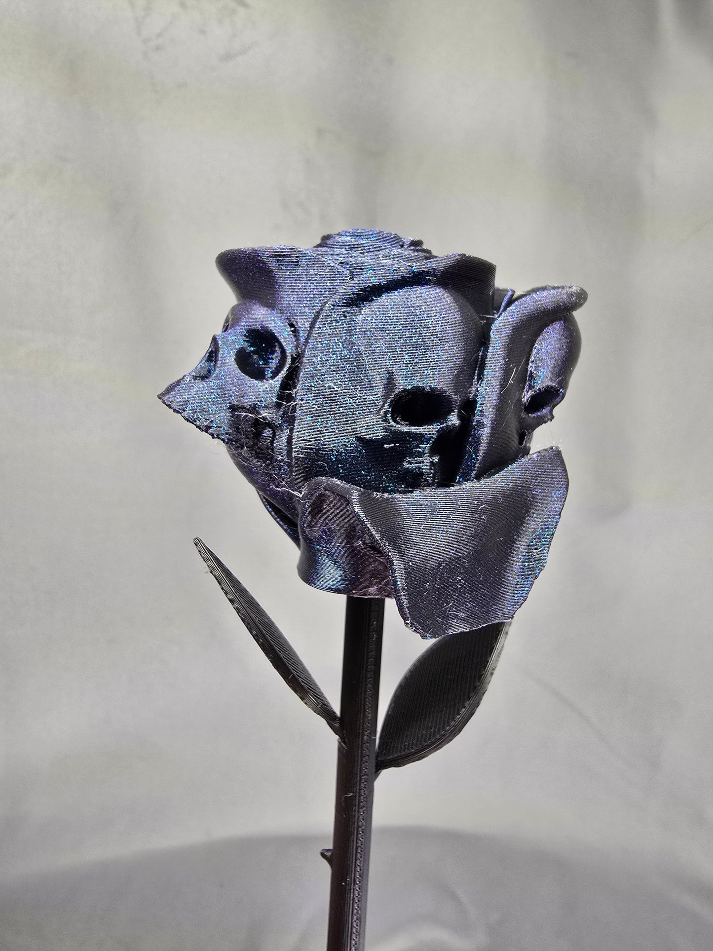 The Forbidden Rose decoration featuring a rose with thorns, 2 leafs and petals with skulls