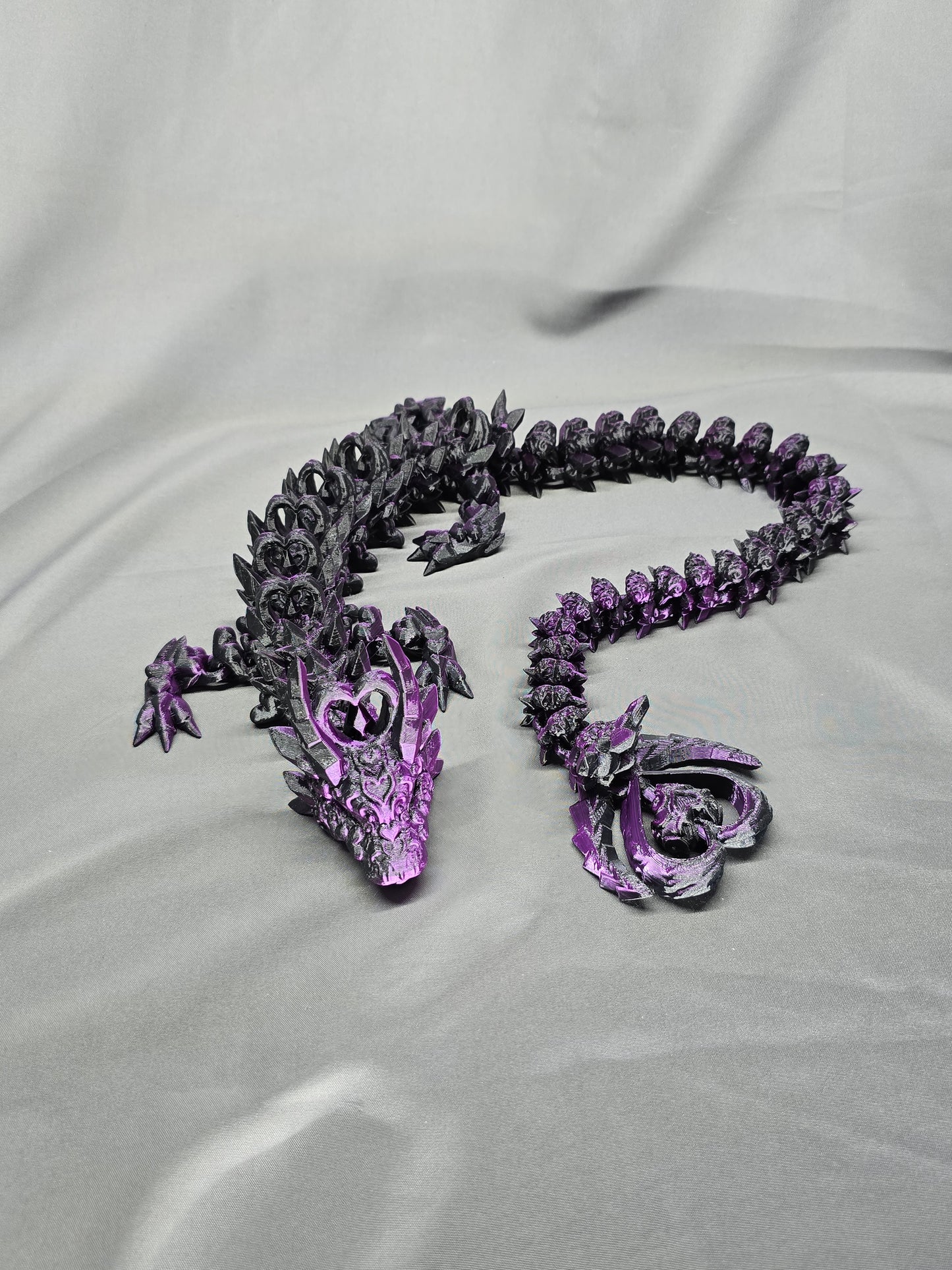 Dark Heart Dragon articulating figurine with a spinning heart tail