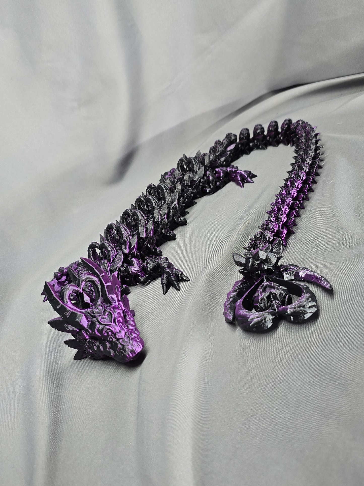 Dark Heart Dragon articulating figurine with a spinning heart tail